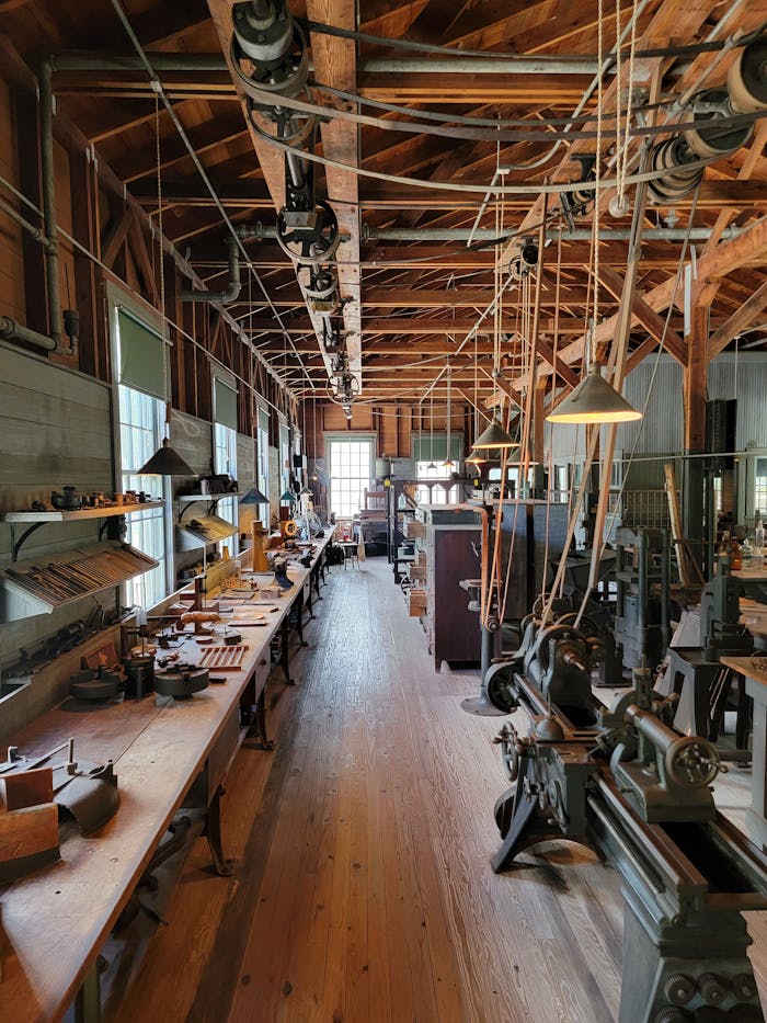 A detailed view of an old workshop filled with vintage machinery and wooden interiors showcasing industrial history.